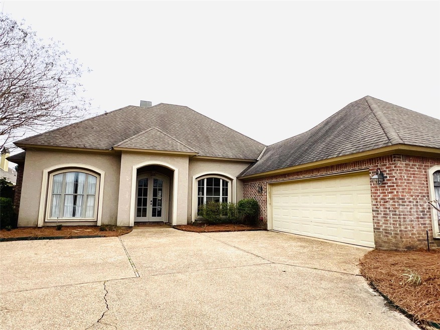 View of front of property featuring a garage and f