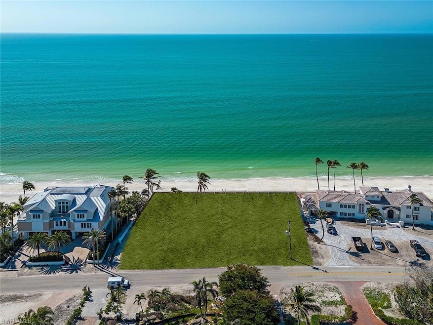 Aerial view featuring a water view and a beach vie