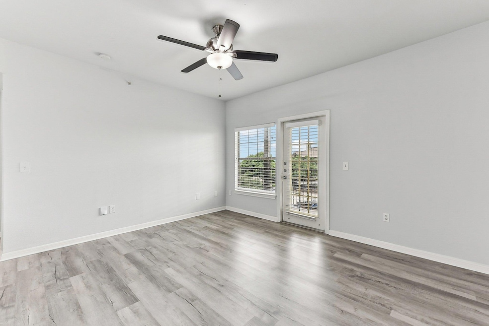 Spare room with ceiling fan, wood finished floors