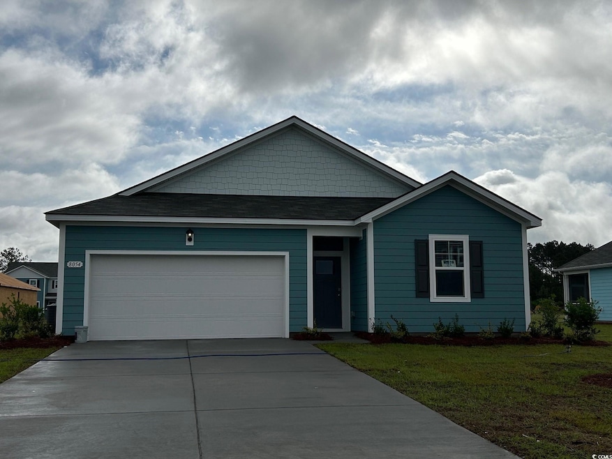 Single story home featuring concrete driveway, a front lawn, and a garage