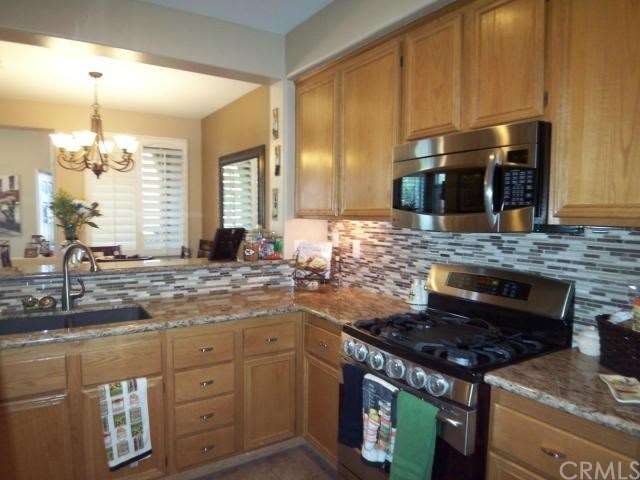 Upgraded kitchen features full tiled backsplash an