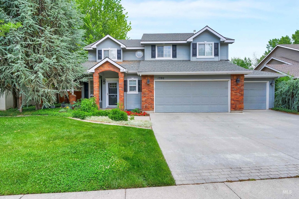 View of front of property with a front lawn, concrete driveway, brick siding, roof with shingles, and a garage