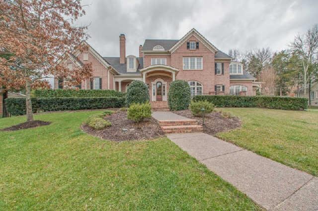 Sprawling home has great curb appeal.  The newly added Portico is flanked by gas lanterns and the covered friends entry provides great access to the second main level suite.