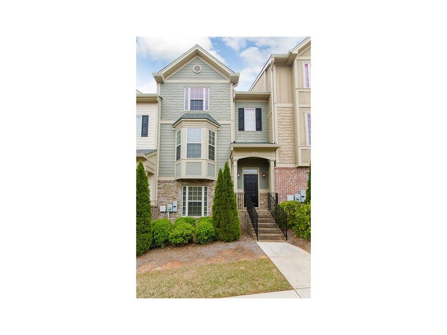 Beautiful townhome with partial brick facade.