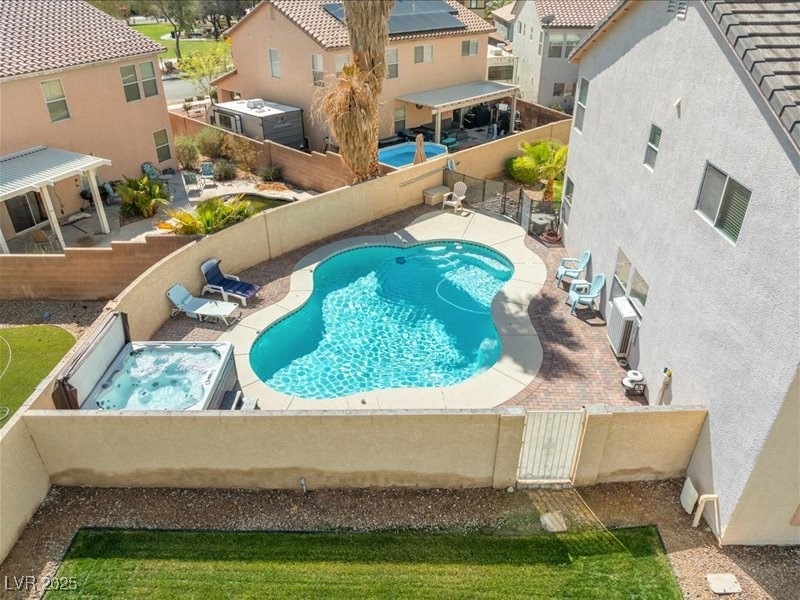 Pool with  a gate, a fenced backyard, a residentia