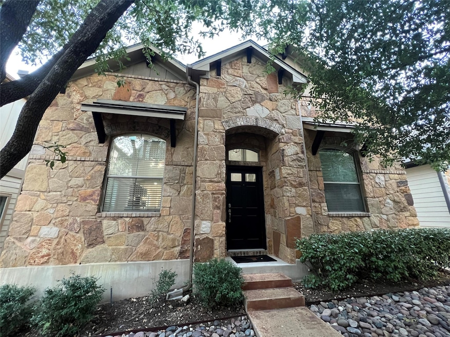 Doorway to property featuring stone siding