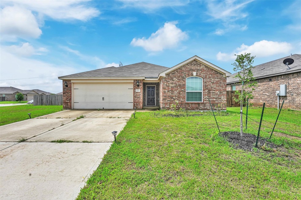 Single story home featuring a garage and a front lawn
