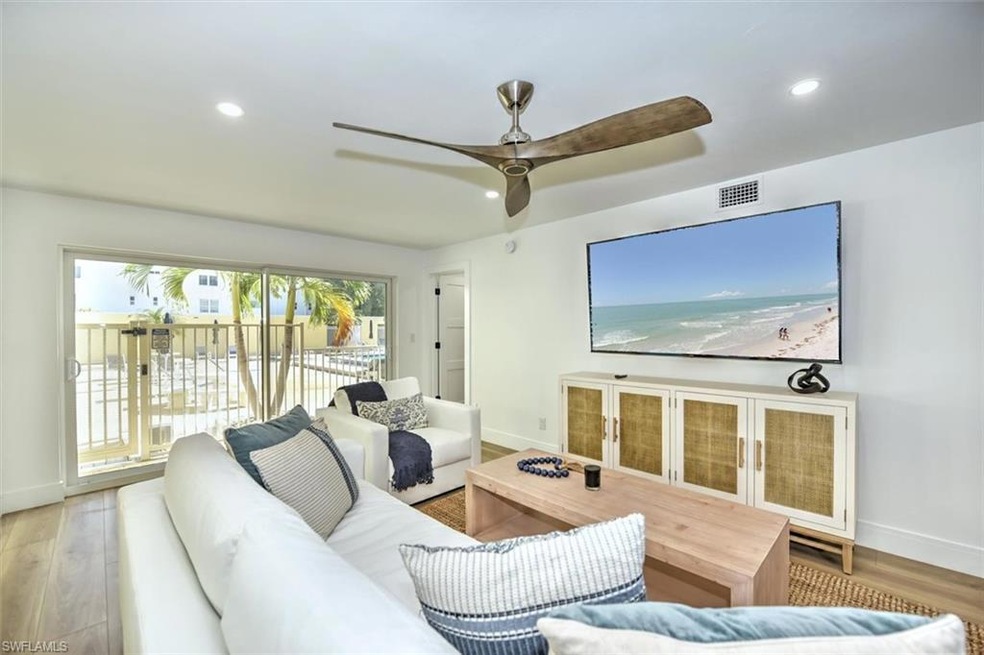 Living room featuring baseboards, wood finished floors, and recessed lighting