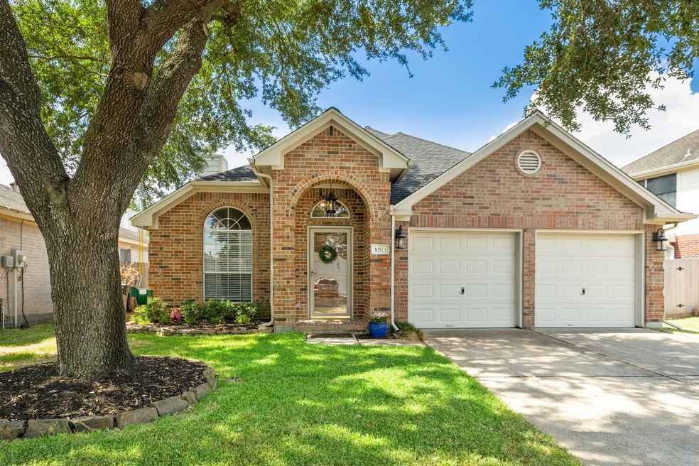 Mature trees and landscaping surround this charmin