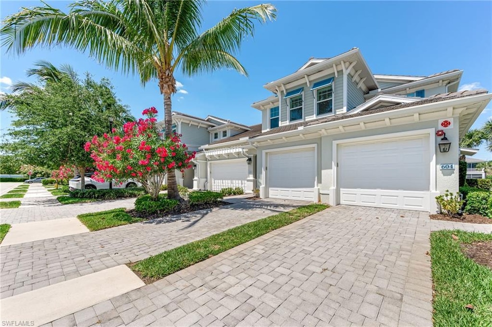 View of front of home with a garage and driveway
