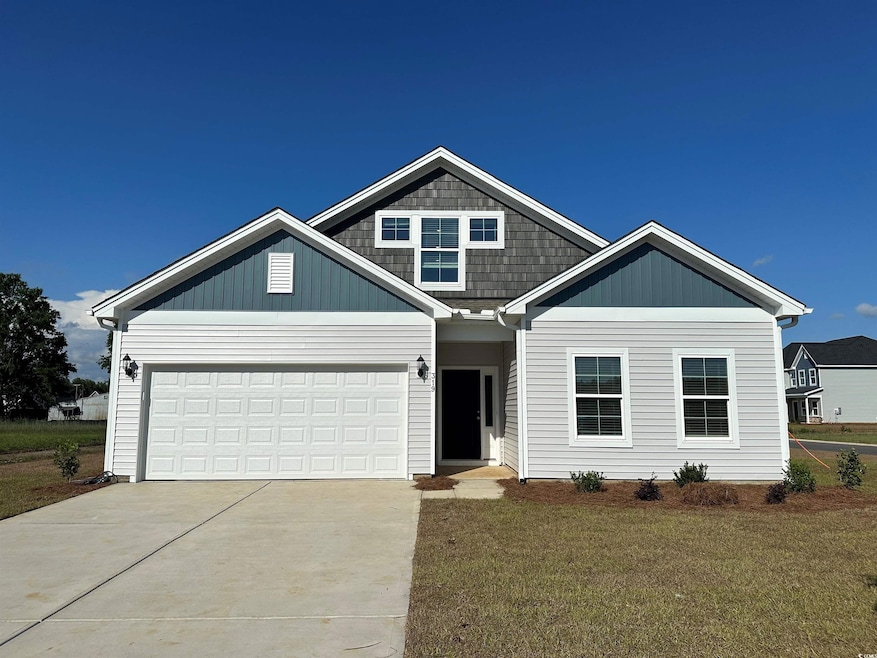 View of front of property with driveway, a front y