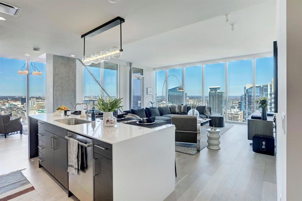Kitchen with a sink, expansive windows, dishwashe