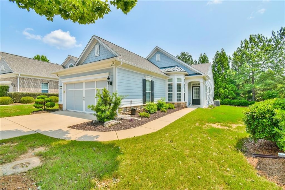 View of front of house with driveway, a front lawn, and a garage