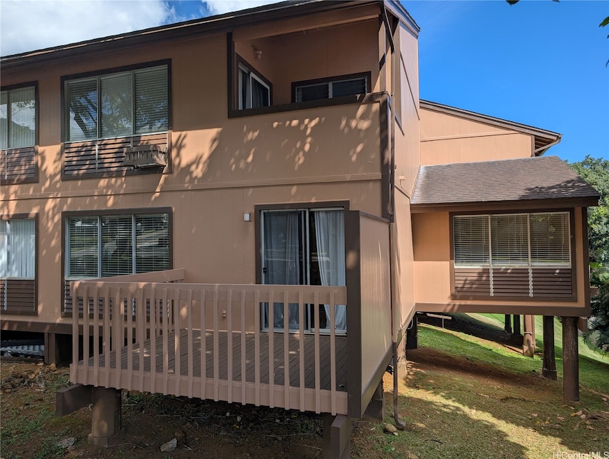 View of unit from Mokulele Drive with wood deck of