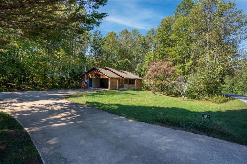 View of front of house with a front yard and a gar