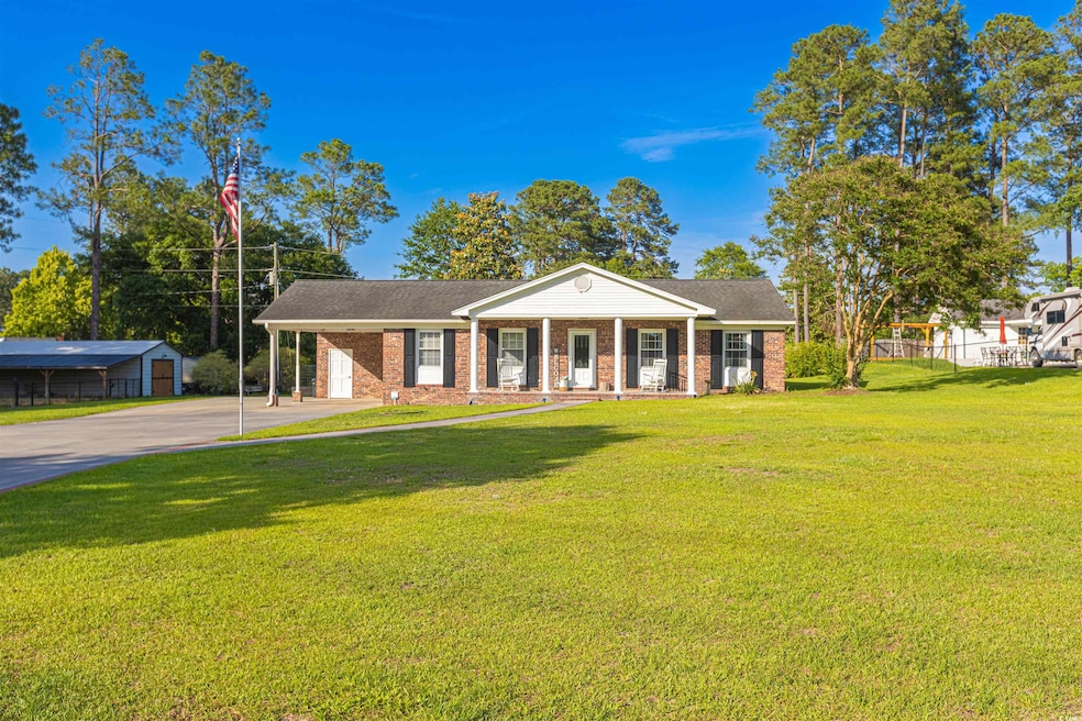 View of front facade featuring driveway, brick sid
