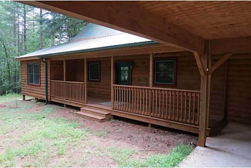 Exterior Front. Beautiful Log Cabin perched above 