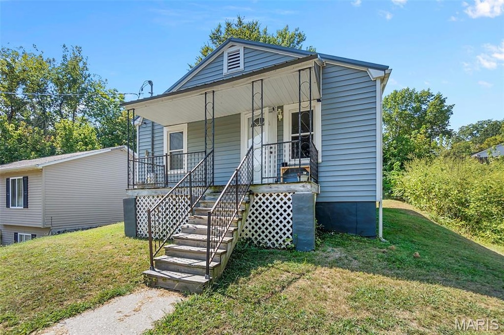 Bungalow-style house with a front lawn, a porch, and stairs