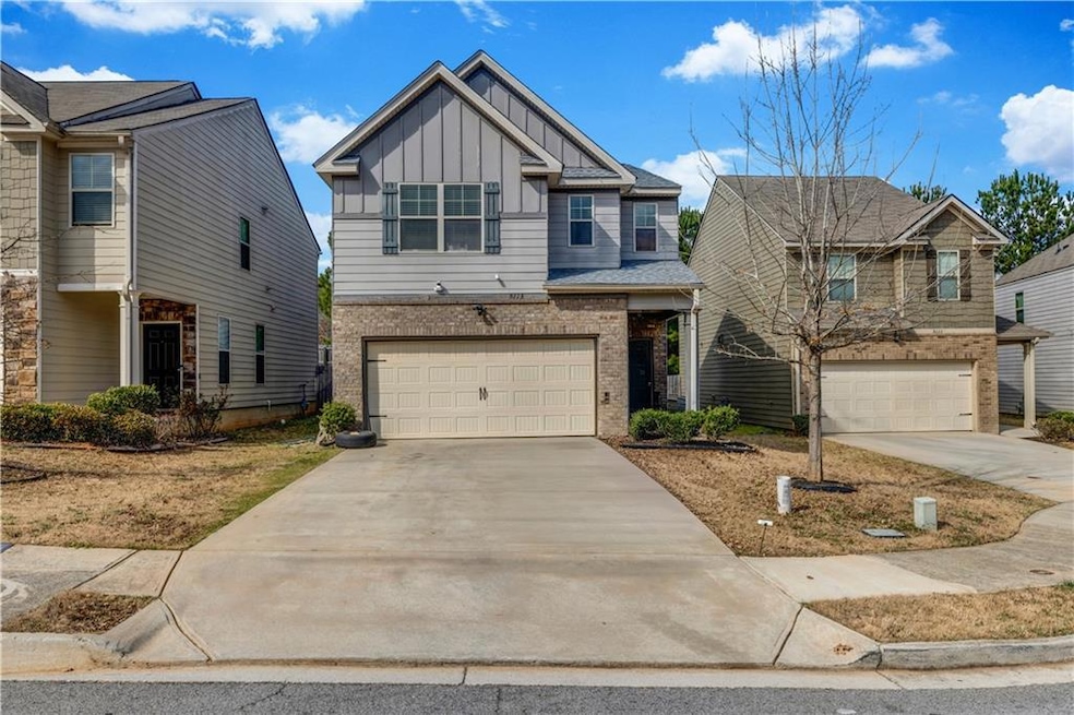 Craftsman-style home with an attached garage, driv