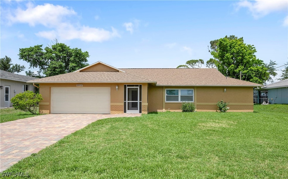 Ranch-style house featuring brick siding, a garage