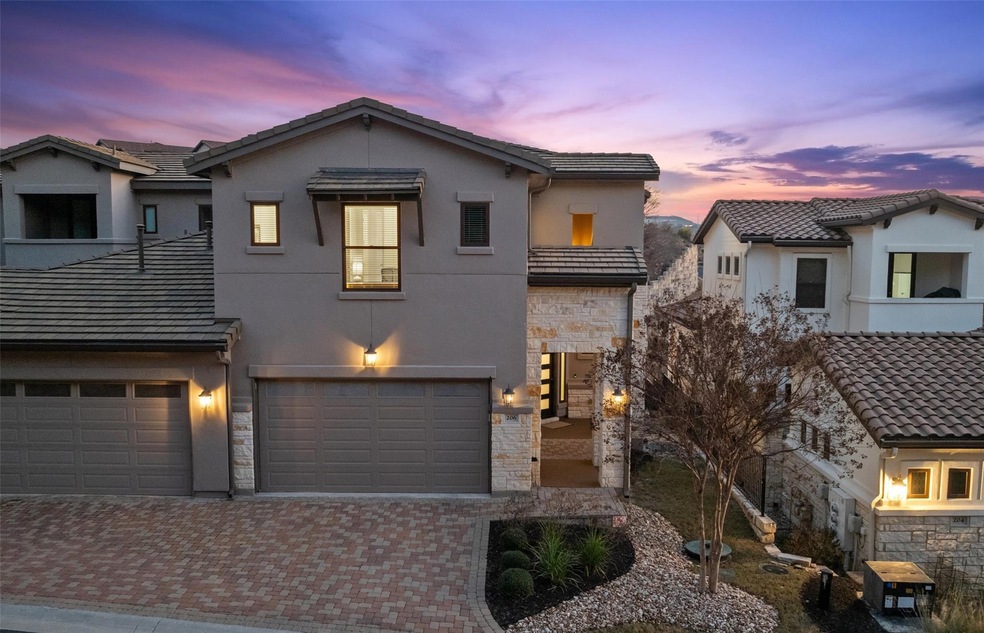View of front of property with stone siding, a til
