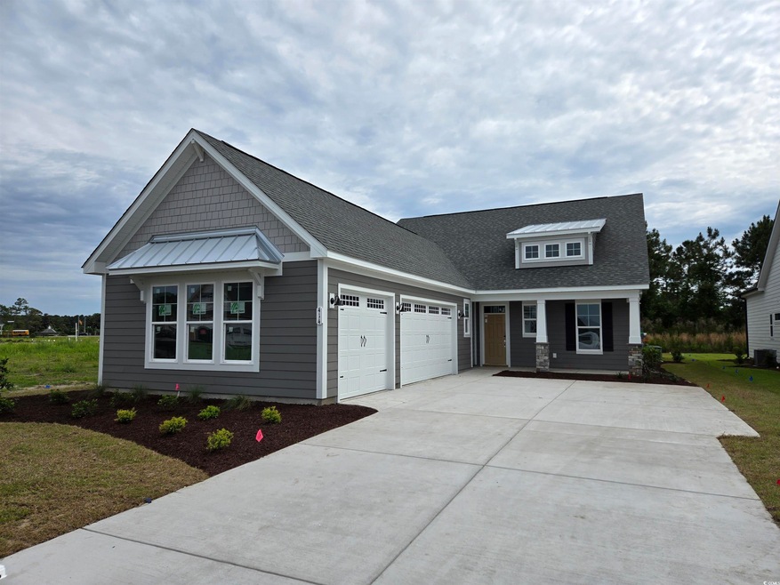 Craftsman-style house featuring an attached garage, concrete driveway, and a porch
