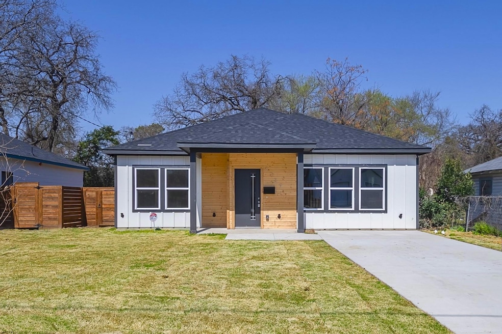 Bungalow featuring concrete driveway, a front yard