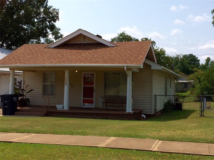 House faces the east with a covered porch and side