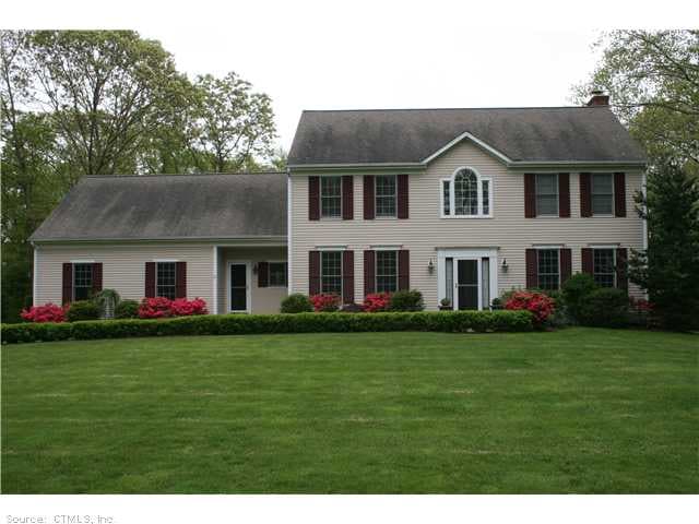 Exterior Front. Professional landscaping frames th