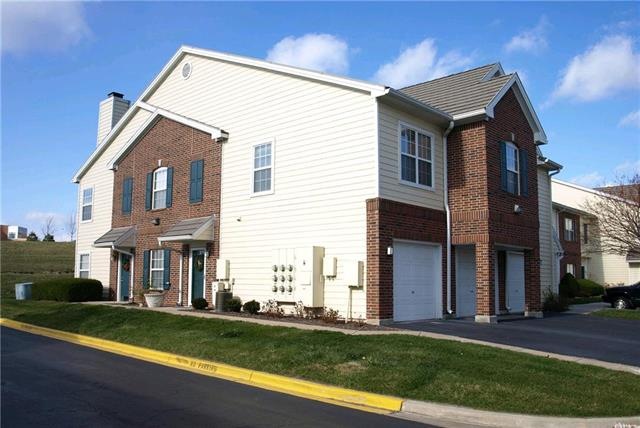view of building, first garage and first entrance 
