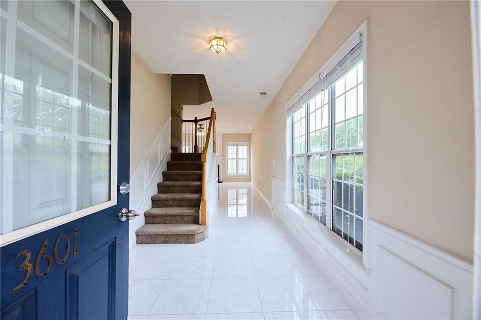 Entryway with stairway and light tile patterned fl