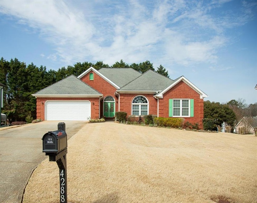 Ranch-style home featuring brick siding, an attach