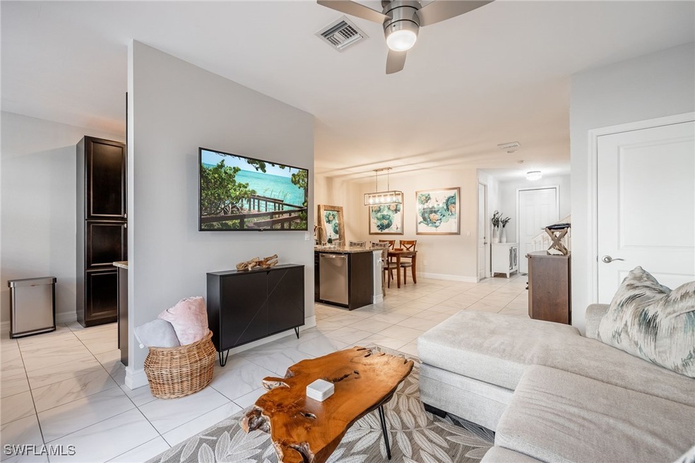 Living area with marble finish floor, ceiling fan,