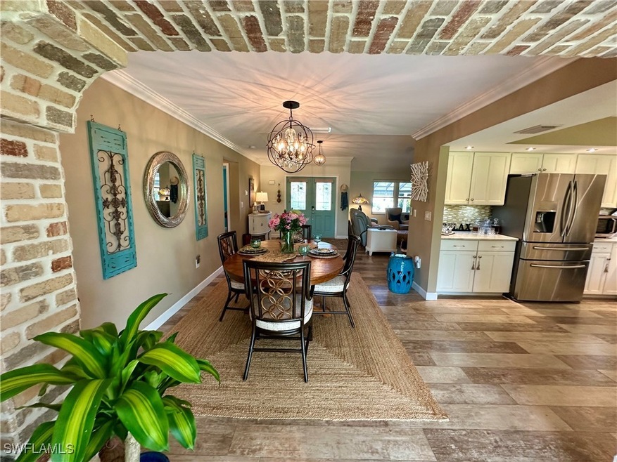 Dining room with crown molding, a chandelier, and