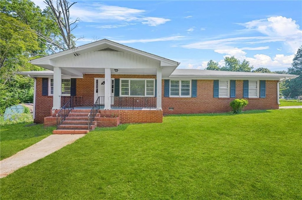 View of front of house featuring brick siding and a front yard