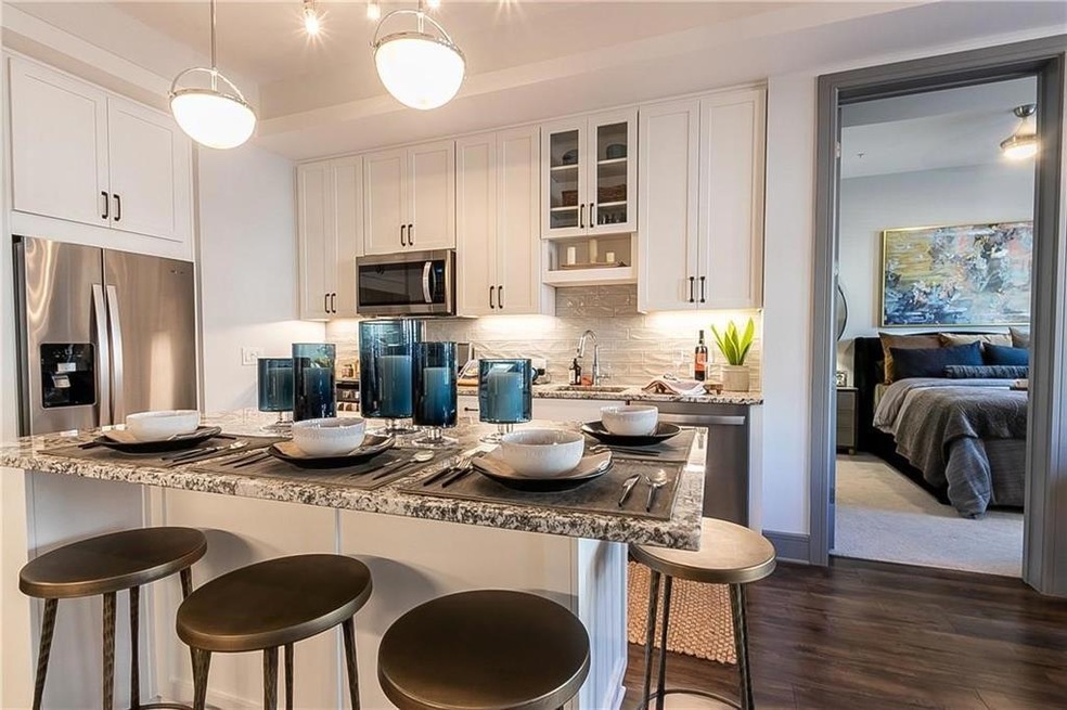 Kitchen with decorative light fixtures, appliances