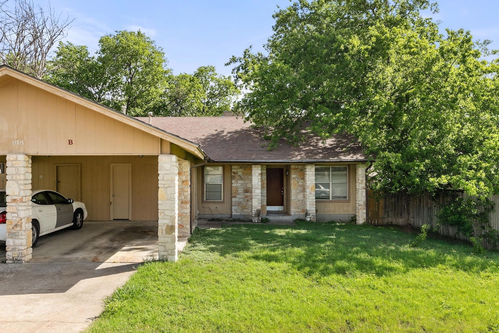 View of front of home with stone siding, roof wit