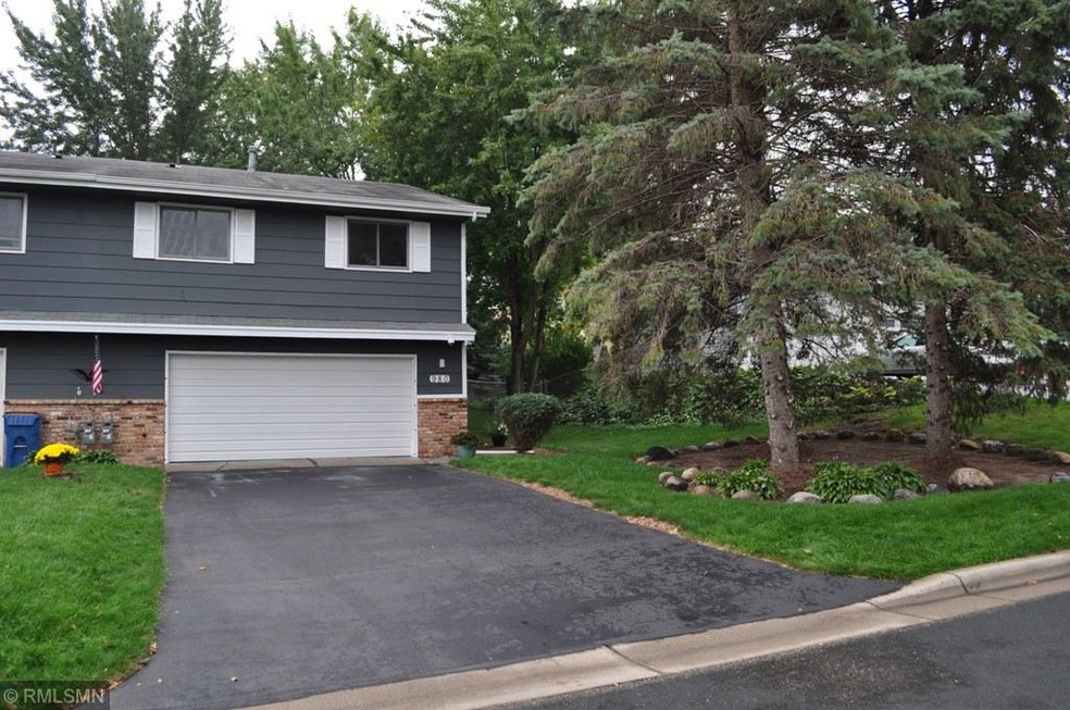 Front with freshly sealed driveway