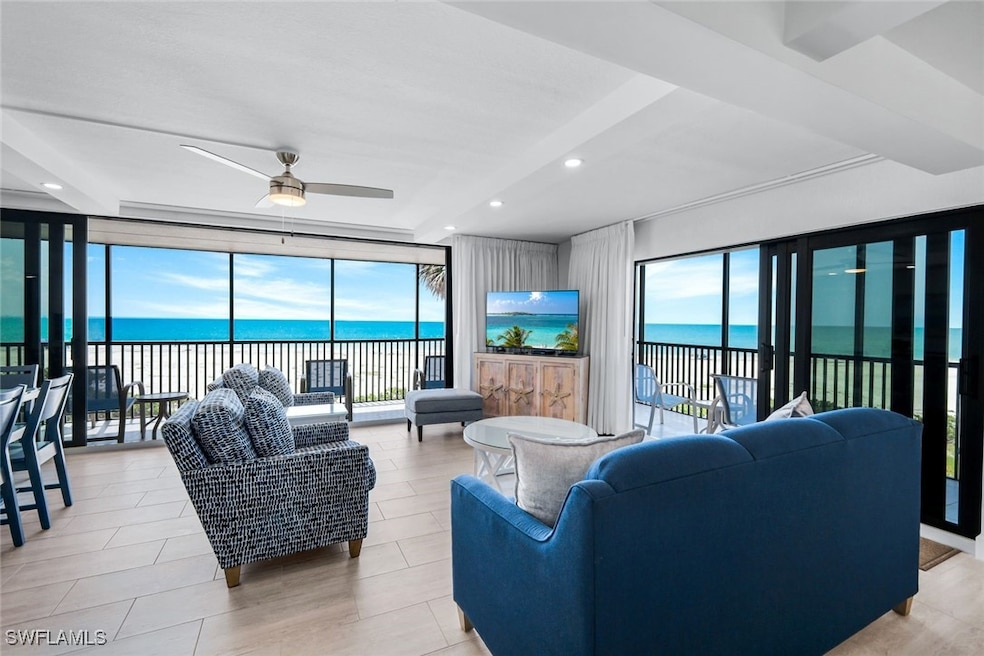Living room with a ceiling fan, recessed lighting,