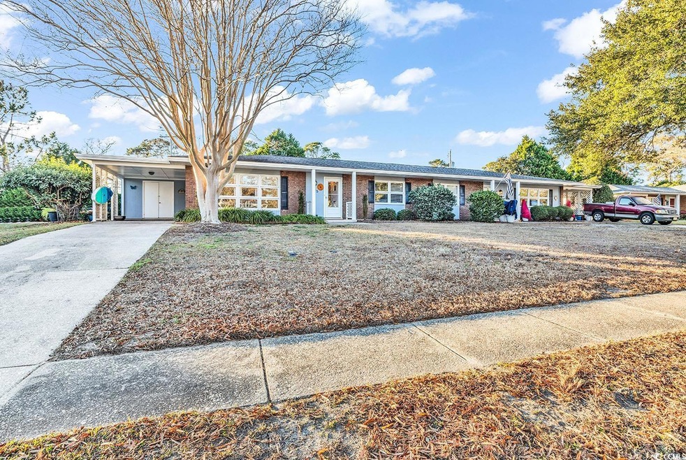 Single story home featuring a carport