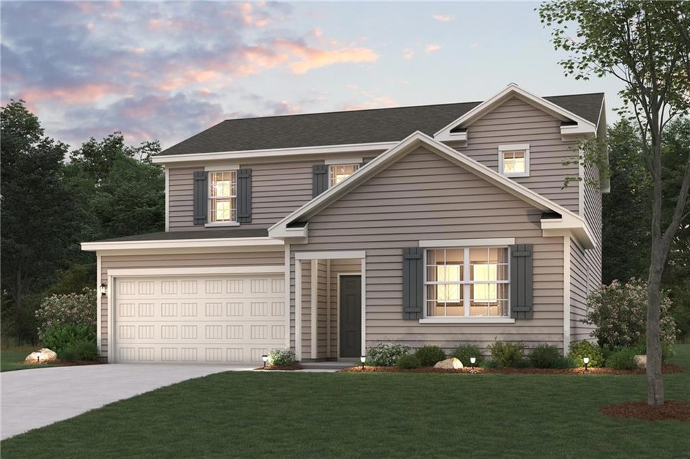 View of property with a garage and a lawn
