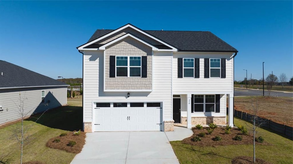 View of front of home featuring a garage and a fro