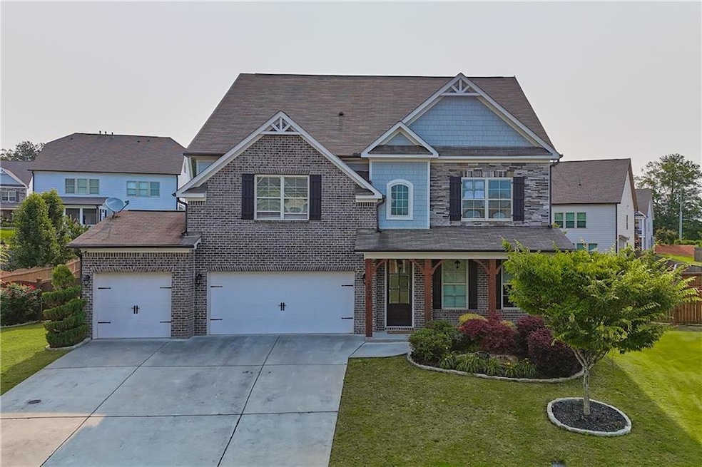 Craftsman inspired home featuring driveway, a front lawn, brick siding, a garage, and a shingled roof