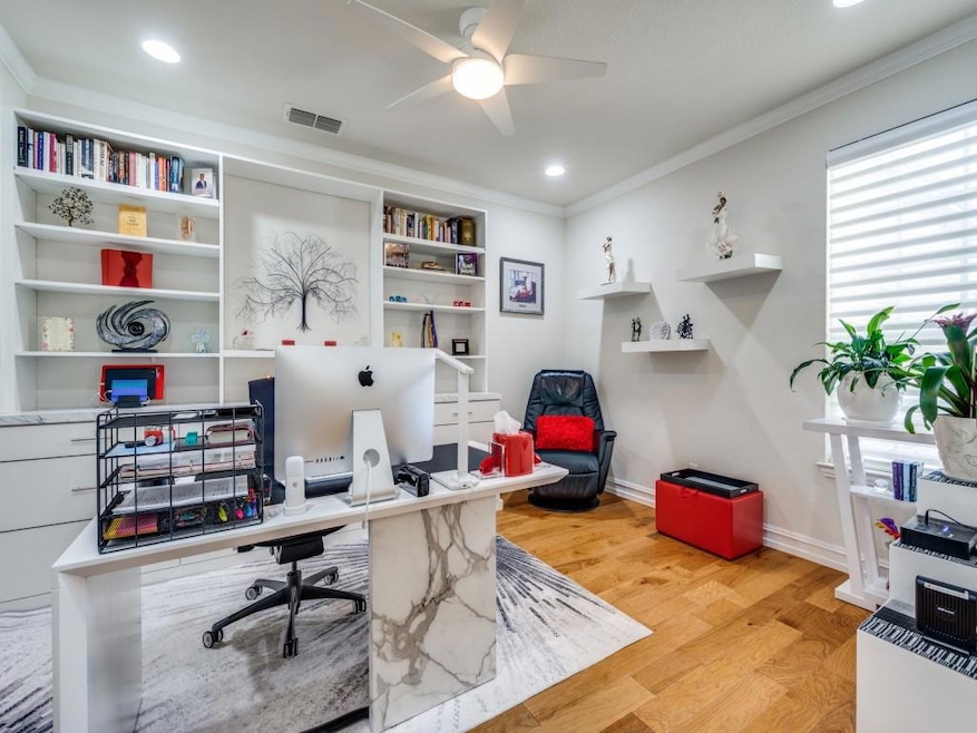 Home office with light hardwood / wood-style floor