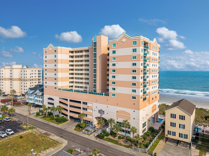 View of building exterior with view of water and beach