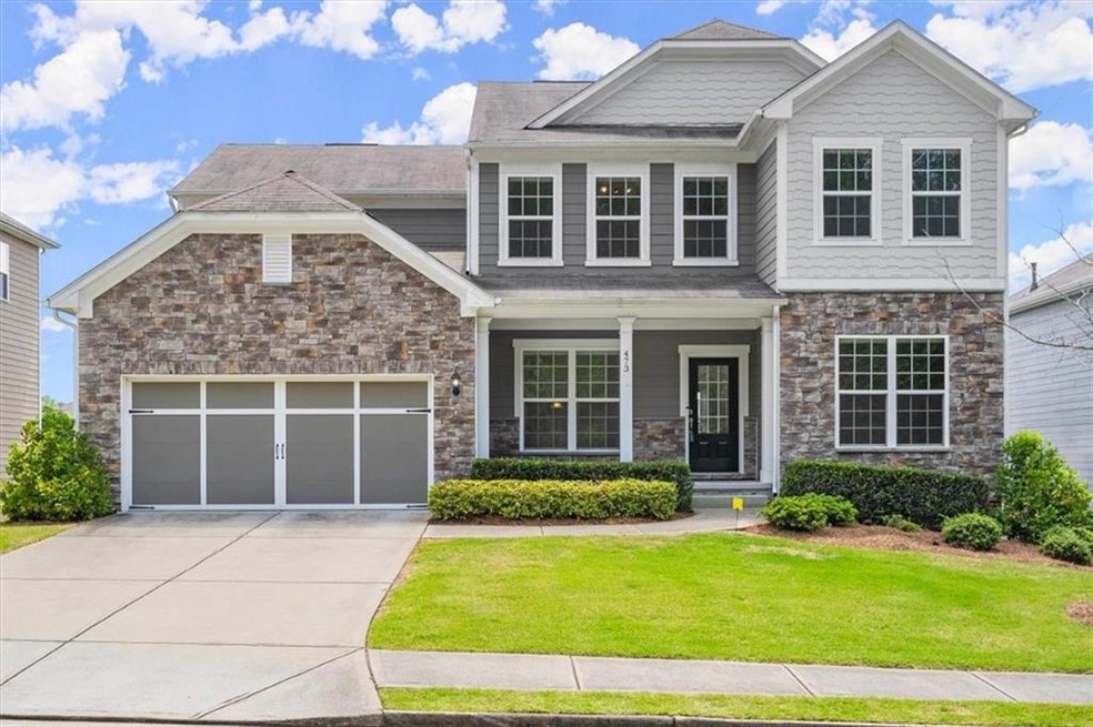 Craftsman-style home with a three car garage