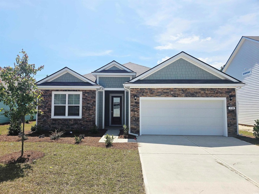 View of front of house with a front yard, a garage
