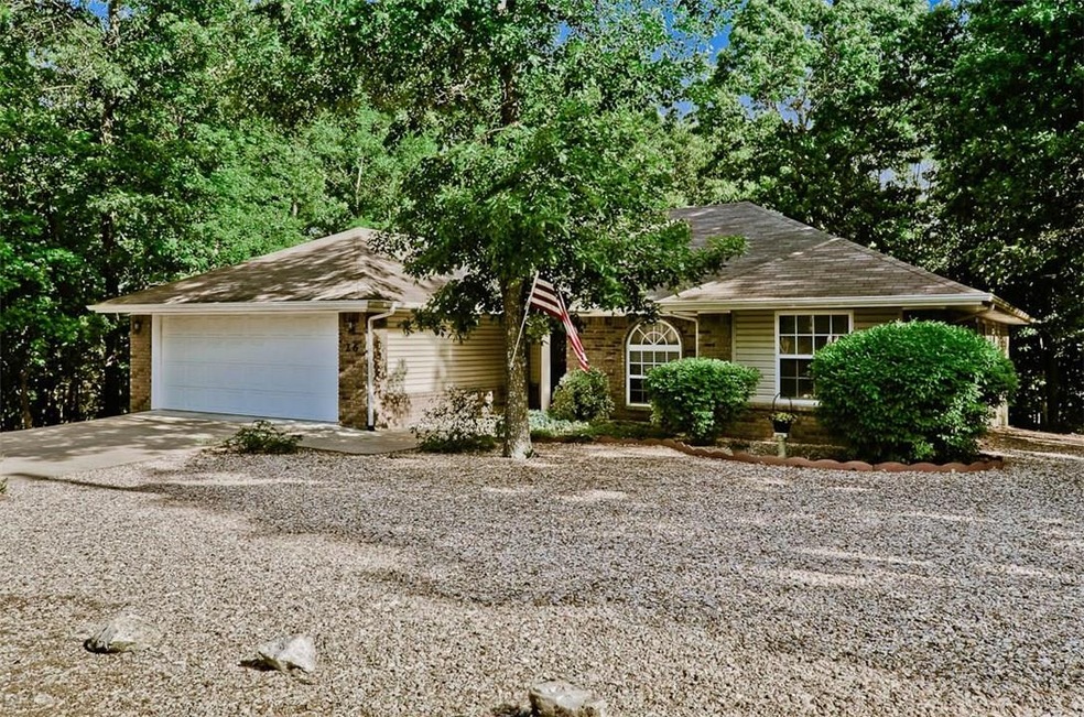 Nestled in the trees, this Bella Vista beauty is m