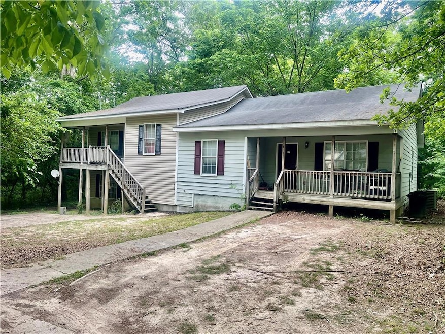 Tri-level home with a porch, roof with shingles, a