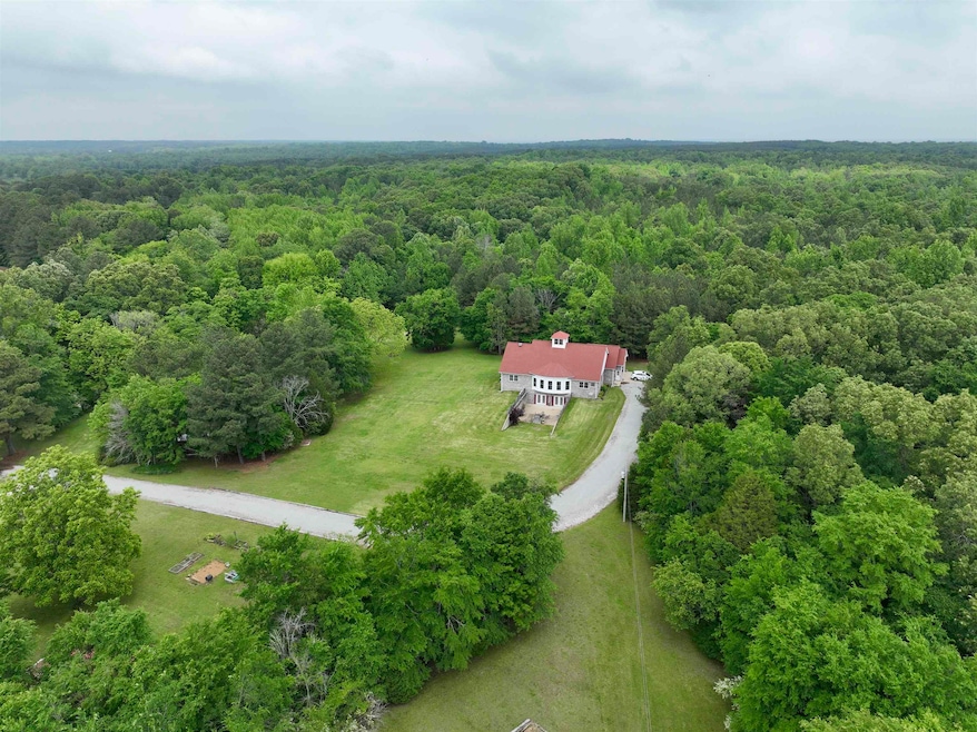 View of subject property with a heavily wooded area